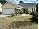 Charming single-story home with a well-manicured lawn and attached two-car garage at 118 Retreat Pl., Little River, SC 29566