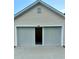 Attached garage with neutral siding and a partial view inside, offering convenient parking at 118 Retreat Pl., Little River, SC 29566