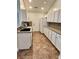 Efficient kitchen with white cabinets, double sink and ample counter space, adjacent to a door at 118 Retreat Pl., Little River, SC 29566