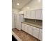 Bright kitchen boasting white cabinets, ample counter space, and modern appliances and neutral flooring at 118 Retreat Pl., Little River, SC 29566