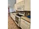 Well-equipped kitchen showcasing modern appliances, white cabinetry and an open view to the living space at 118 Retreat Pl., Little River, SC 29566