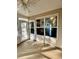 The enclosed sunroom features a ceiling fan, windows, and access to the home's interior and exterior at 118 Retreat Pl., Little River, SC 29566