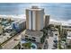 Aerial view of the condo complex with a courtyard pool, parking, and a sea view at 1207 S Ocean Blvd. # 20109, Myrtle Beach, SC 29577