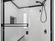 A modern shower featuring glass doors and sleek black fixtures at 1207 S Ocean Blvd. # 20109, Myrtle Beach, SC 29577