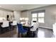 Well-lit dining area with hardwood floors and views of green fields out the window at 1416 Whistling Straits Way, Sunset Beach, NC 28468