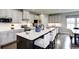 Open concept kitchen with an island, white cabinets, and stainless steel appliances at 1416 Whistling Straits Way, Sunset Beach, NC 28468