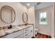 Bathroom featuring a double sink vanity, granite countertops and large oval mirrors at 142 Temple Dr., Aynor, SC 29511