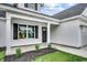 Charming home featuring a welcoming front porch, black shutters, and well-maintained landscaping at 142 Temple Dr., Aynor, SC 29511