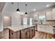 Spacious kitchen featuring a central island, stainless appliances, and stylish pendant lighting at 142 Temple Dr., Aynor, SC 29511