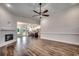 Open concept living room featuring a fireplace, wood floors, and seamless transition to kitchen at 142 Temple Dr., Aynor, SC 29511