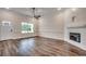 Spacious living room with fireplace, wood flooring, and natural light creates a welcoming atmosphere at 142 Temple Dr., Aynor, SC 29511