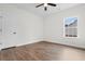 Bright bedroom featuring hardwood floors, ceiling fan, and a window letting in natural light at 146 Temple Dr., Aynor, SC 29511