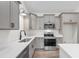 Well-lit kitchen featuring gray cabinets, quartz countertops, and stainless steel appliances at 146 Temple Dr., Aynor, SC 29511