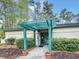 Exterior view of the Amenity Center with green pergola and landscaping featuring potted plants at 1551 Spinnaker Dr. # 5913, North Myrtle Beach, SC 29582