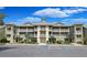 Inviting condo exterior showcasing ample parking, landscaping, and multiple covered balconies at 1551 Spinnaker Dr. # 5913, North Myrtle Beach, SC 29582