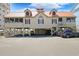 Coastal home with a red roof, screened porch, and ample parking beneath the elevated structure at 1551 Spinnaker Dr. # 5913, North Myrtle Beach, SC 29582