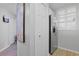 Bright hallway featuring a stainless steel refrigerator, closet doors, and hardwood floors at 1551 Spinnaker Dr. # 5913, North Myrtle Beach, SC 29582