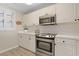 Bright kitchen featuring stainless steel appliances, white cabinets, and ample counter space at 1551 Spinnaker Dr. # 5913, North Myrtle Beach, SC 29582