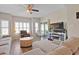 Comfortable living room featuring a ceiling fan, hardwood floors, and sliding glass doors to a balcony at 1551 Spinnaker Dr. # 5913, North Myrtle Beach, SC 29582