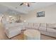 Bright living room showcasing a large sectional sofa, hardwood floors, and an open view of the kitchen at 1551 Spinnaker Dr. # 5913, North Myrtle Beach, SC 29582