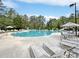 Large community pool surrounded by lounge chairs, umbrellas, and lush trees, perfect for hot days at 1551 Spinnaker Dr. # 5913, North Myrtle Beach, SC 29582