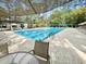 Community pool surrounded by mature trees and lounge chairs, creating a relaxing and inviting atmosphere at 1551 Spinnaker Dr. # 5913, North Myrtle Beach, SC 29582