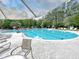 Inviting community pool with lounge chairs, umbrellas, and mature trees offering shade and relaxation at 1551 Spinnaker Dr. # 5913, North Myrtle Beach, SC 29582