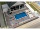 A high-angle aerial view of the backyard pool and patio, surrounded by white fencing for added privacy at 1616 S Ocean Blvd., North Myrtle Beach, SC 29582