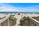 Inviting beach access with wooden stairs leading to the sandy shore, perfect for enjoying the ocean views at 1616 S Ocean Blvd., North Myrtle Beach, SC 29582