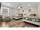 Inviting bedroom featuring two twin beds, a ceiling fan, and a cozy armchair creating a relaxing space at 1616 S Ocean Blvd., North Myrtle Beach, SC 29582