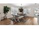 Dining area with a large wooden table, seating, and an abundance of natural light from the windows at 1616 S Ocean Blvd., North Myrtle Beach, SC 29582