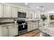 Modern kitchen with stainless steel appliances, granite countertops, and custom cabinetry at 1616 S Ocean Blvd., North Myrtle Beach, SC 29582