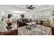 Cozy living room with plush leather couches, ceiling fan, and a decorative rug under a coffee table at 1616 S Ocean Blvd., North Myrtle Beach, SC 29582