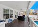 Spacious covered porch featuring cozy seating, perfect for enjoying outdoor living and poolside relaxation at 1616 S Ocean Blvd., North Myrtle Beach, SC 29582