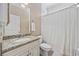 Bathroom featuring granite countertop, vanity, mirror, and shower with curtain and tiled floor at 175 Summer Wind Loop, Murrells Inlet, SC 29576
