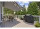 Outdoor deck featuring a grill, table with chairs, retractable awning, and lush greenery at 175 Summer Wind Loop, Murrells Inlet, SC 29576
