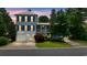 Charming two-story home with a well-maintained lawn, illuminated by outdoor lighting, perfect for a Gathering at 175 Summer Wind Loop, Murrells Inlet, SC 29576