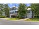 Charming two-story home with well-manicured lawn, garage, and inviting curb appeal in a lush setting at 175 Summer Wind Loop, Murrells Inlet, SC 29576
