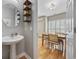 Hallway leading to dining area with views of natural light and dining table set for meal at 175 Summer Wind Loop, Murrells Inlet, SC 29576