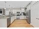 Bright kitchen features stainless appliances, granite countertops, hardwood floors, and ample cabinet space at 175 Summer Wind Loop, Murrells Inlet, SC 29576