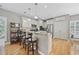 Bright kitchen with stainless steel appliances, stone countertops, hardwood floors, and barstool seating at 175 Summer Wind Loop, Murrells Inlet, SC 29576