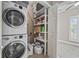 Bright laundry area featuring stacked washer and dryer with built-in shelving for storage at 175 Summer Wind Loop, Murrells Inlet, SC 29576