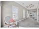 Spacious living area featuring a chair, large windows, carpet flooring, and ceiling fan at 175 Summer Wind Loop, Murrells Inlet, SC 29576