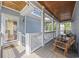 Cozy covered porch with wood ceiling, rocking chairs, and string lights, offering a perfect spot for relaxing at 175 Summer Wind Loop, Murrells Inlet, SC 29576