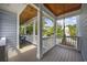 Inviting covered porch with wood ceiling, white railings, string lights, and a relaxing hammock for ultimate relaxation at 175 Summer Wind Loop, Murrells Inlet, SC 29576