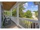 Charming covered porch with wood ceiling, string lights, and comfortable seating overlooking a lush, green lawn at 175 Summer Wind Loop, Murrells Inlet, SC 29576
