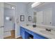 Bathroom featuring double sink vanity with blue cabinets and a large mirror at 1912 Goose Creek Rd. Sw # 4302, Ocean Isle Beach, NC 28469