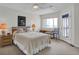 Comfortable bedroom with light colored walls, ceiling fan, and balcony access at 1912 Goose Creek Rd. Sw # 4302, Ocean Isle Beach, NC 28469