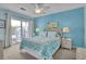 Bright bedroom with coastal decor, balcony access, ceiling fan, and neutral carpet at 1912 Goose Creek Rd. Sw # 4302, Ocean Isle Beach, NC 28469