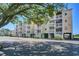 Coastal condos showcasing balconies and ground-level parking, enhanced by lush tree shade at 1912 Goose Creek Rd. Sw # 4302, Ocean Isle Beach, NC 28469
